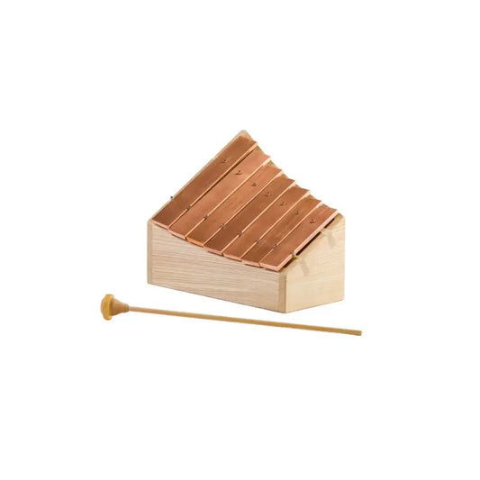 Wooden copper and wood pentatonic glockenspiel with a mallet on a white background