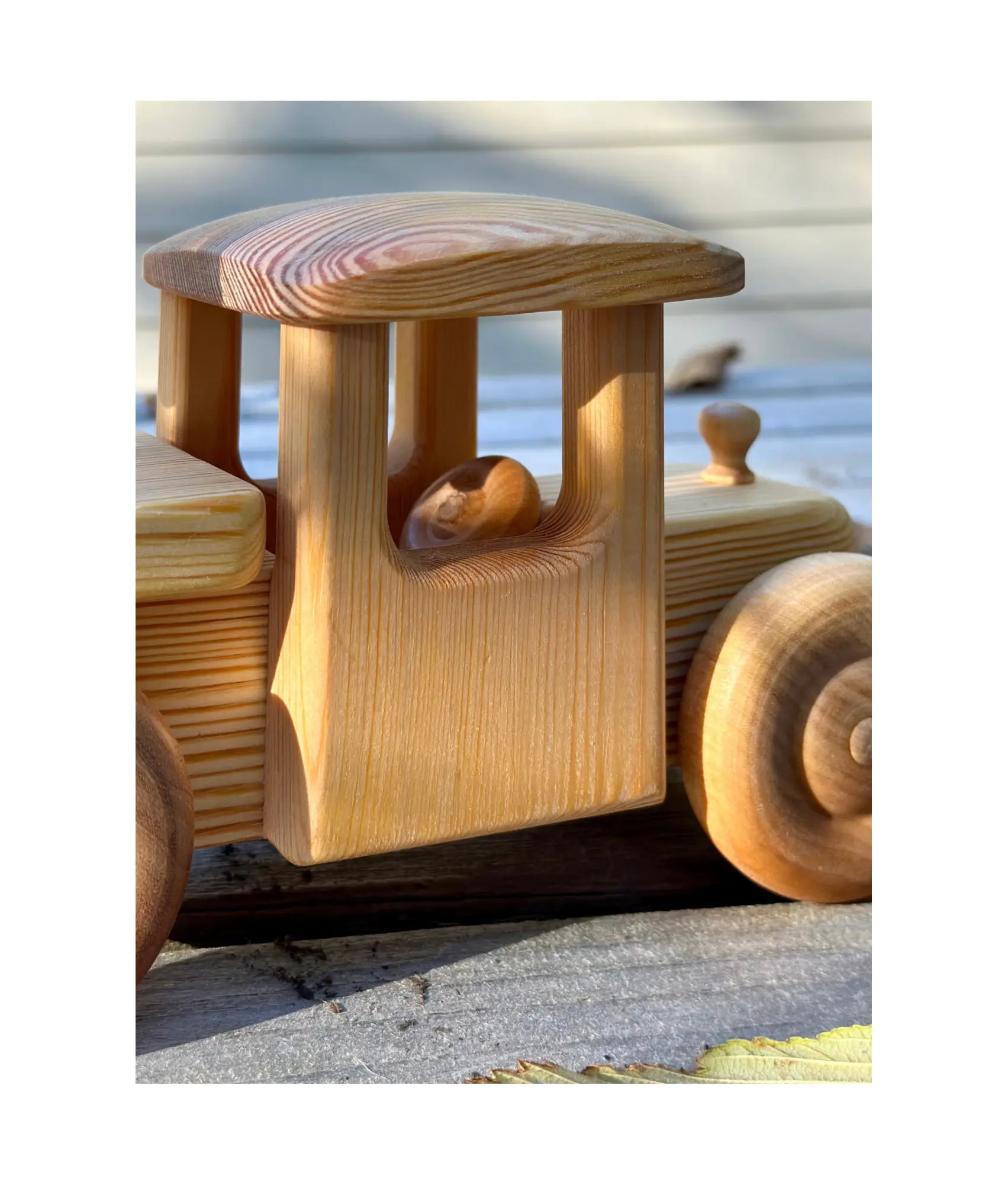 Wooden toy truck with a detailed design on a white background