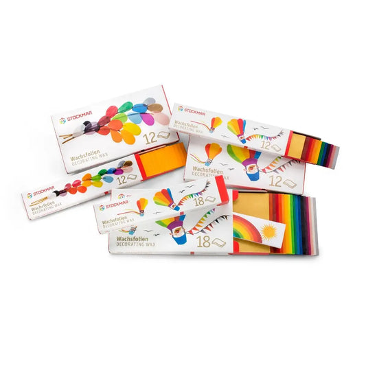 Stockmar Decorating Wax Sheets in Narrow and Wide Sizes in a pile on a white background