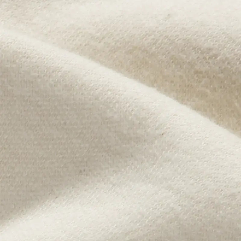 Close-up of white organic doll making fabric texture