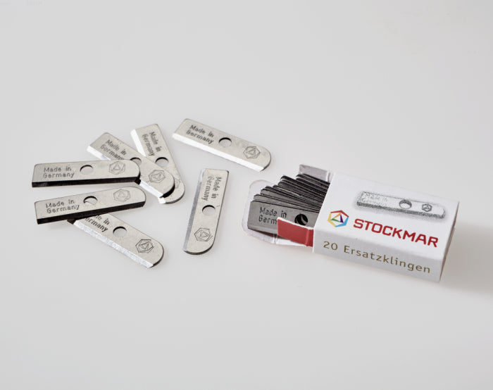 Stockmar Dual Pencil Sharpener Replacement Blades spilling out of it's box on a white background