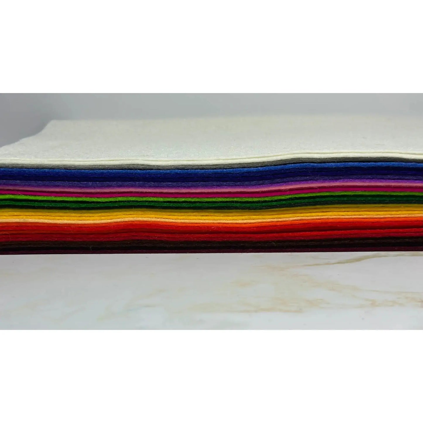 Stack of colorful European Wool Felt Craft sheets on a white background