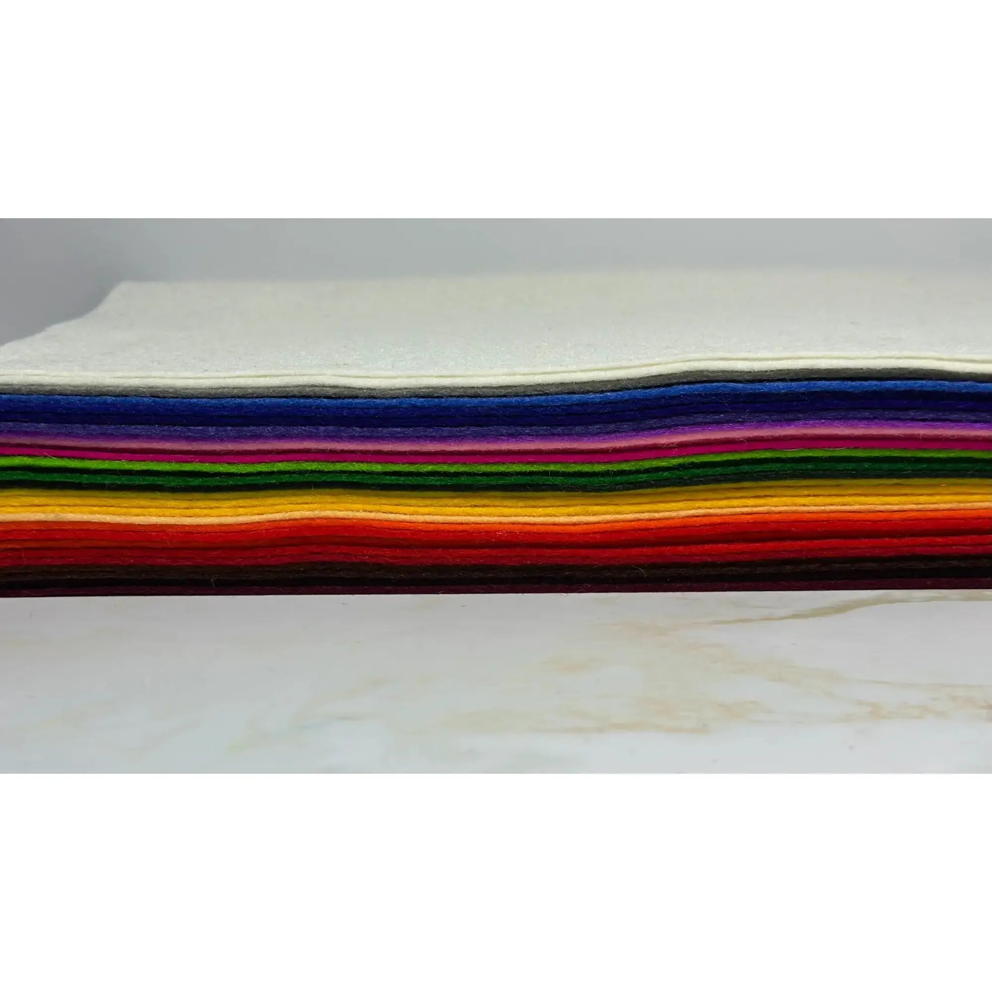 Stack of colorful European Wool Felt Craft sheets on a white background