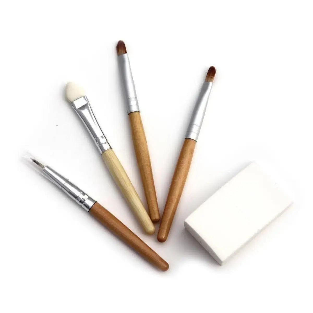 Set of makeup brushes with wooden handles on a white background