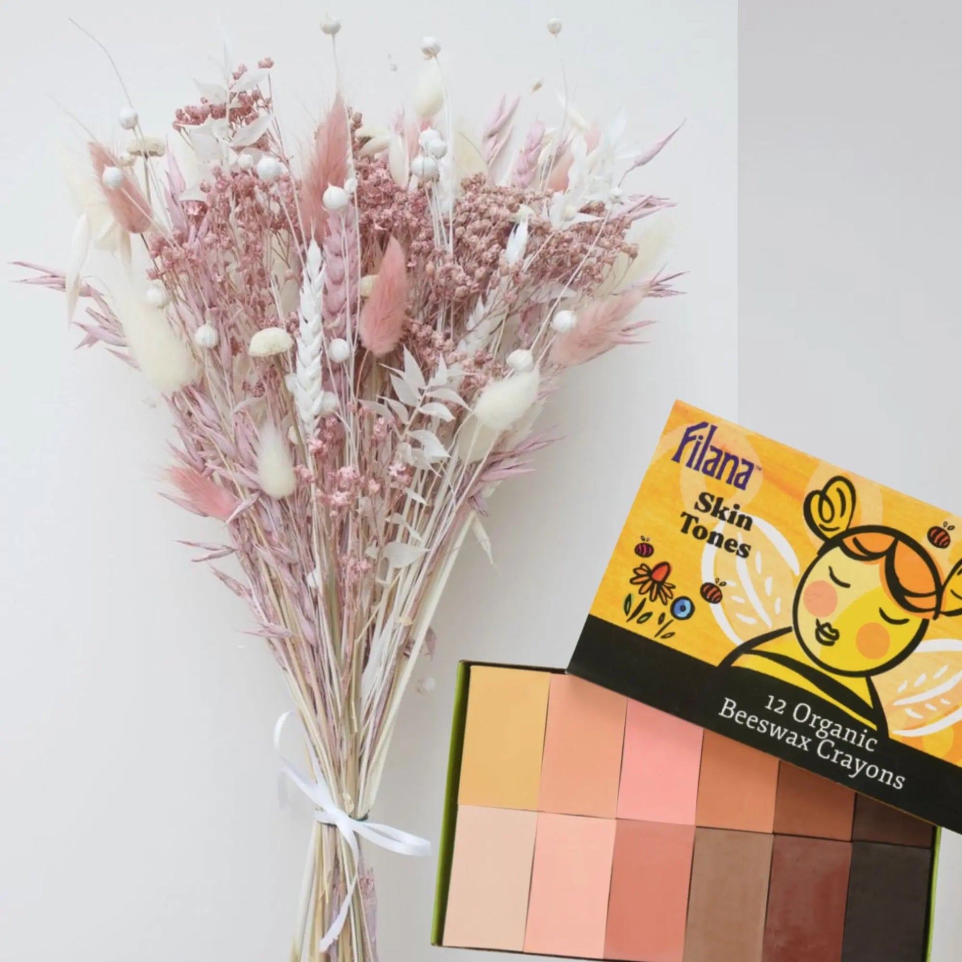 Filana Skin Tones crayon set with dried flowers on a white background