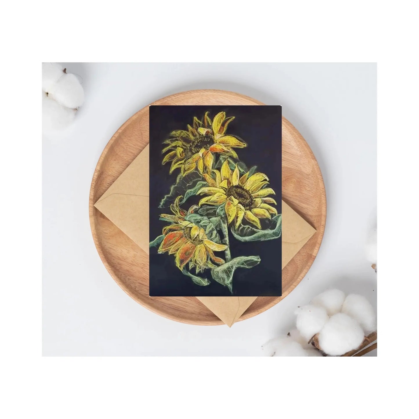 Card with sunflower design on a wooden plate with an envelope