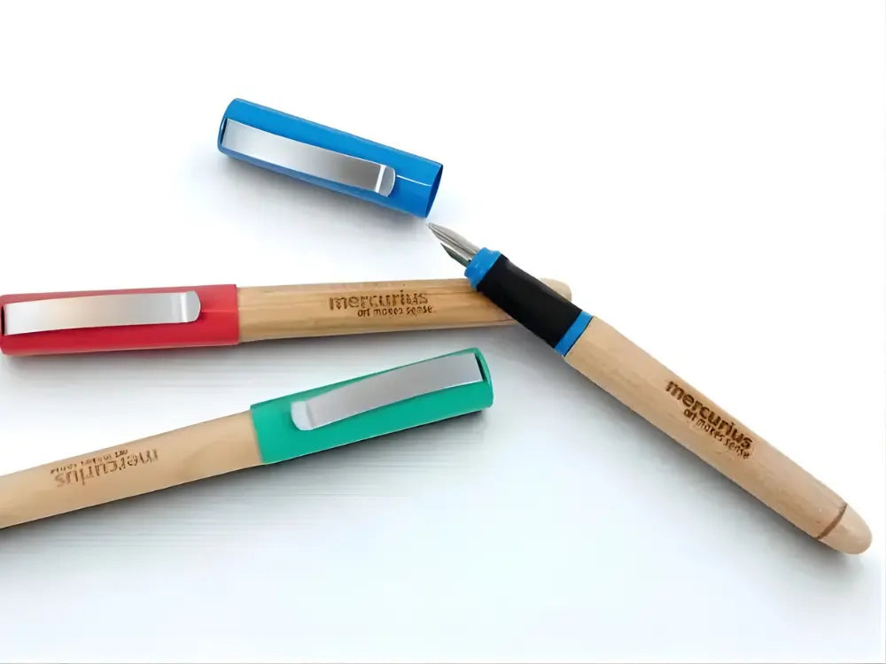 Three Greenfield calligraphy pens with wooden barrels on a light background