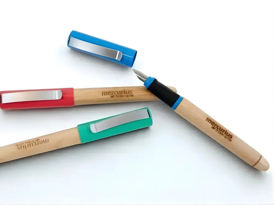 Three Greenfield calligraphy pens with wooden barrels on a light background