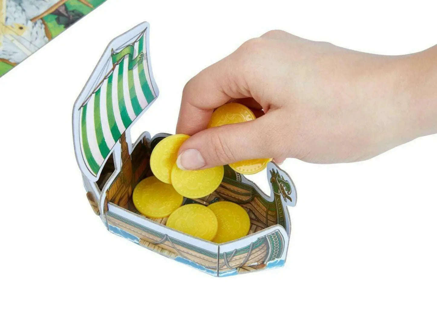 A Hand dropping coins into the Valley of Vikings Ship on white background