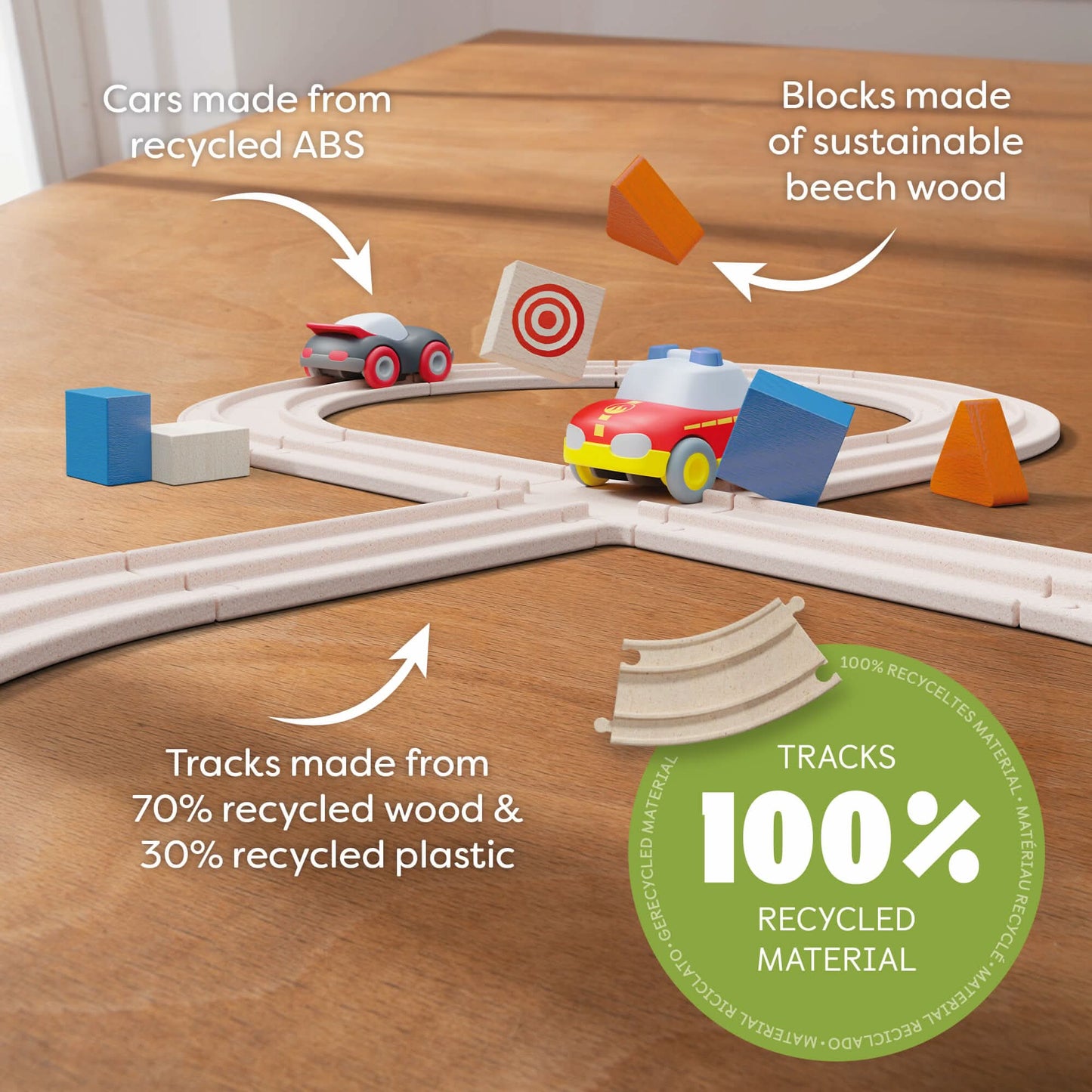 Toy track set with cars and blocks on a wooden surface, highlighting eco-friendly materials.