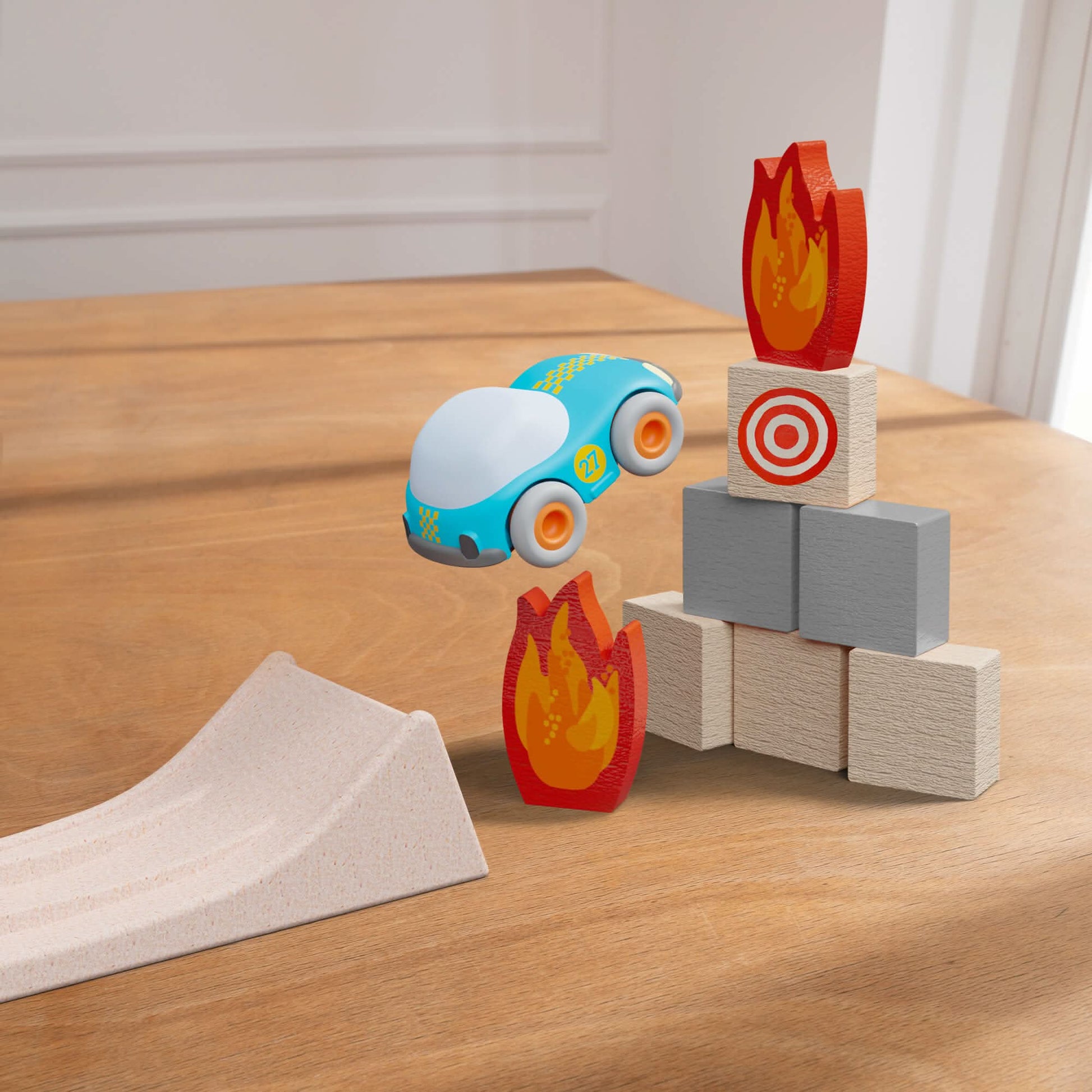 Toy car near wooden blocks with fire designs on a wooden surface