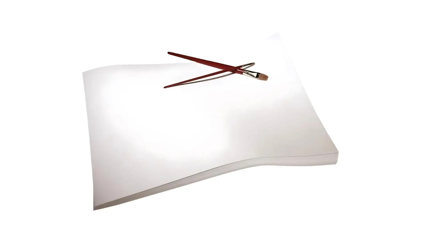 Stack of watercolor paper with two paintbrushes on a white background