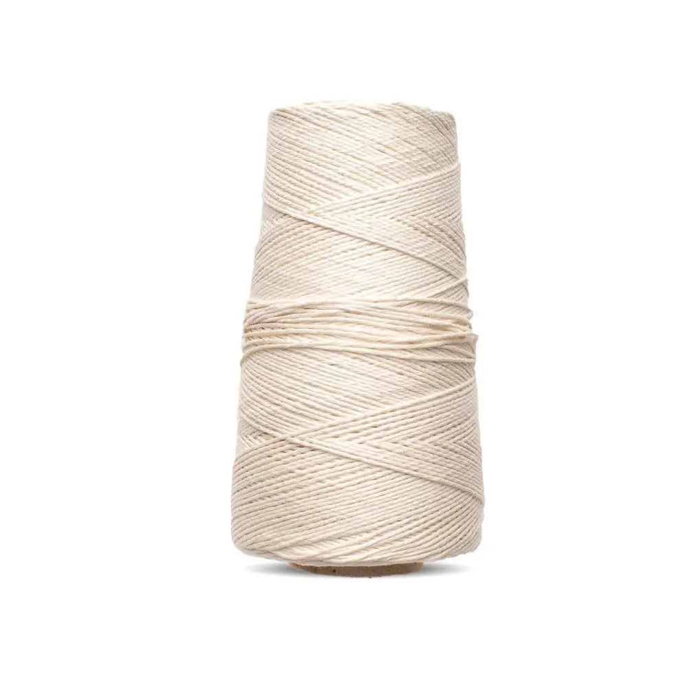 Spool of cotton warp thread for looms on a white background