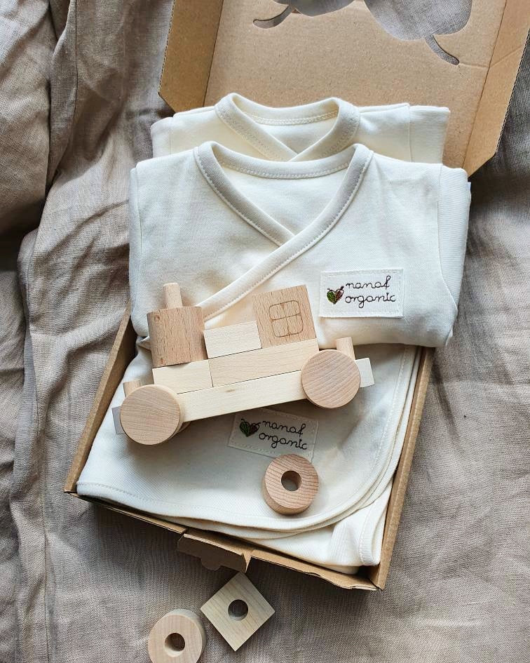 Wooden Toy Train with Stacking Blocks on top of a gift box