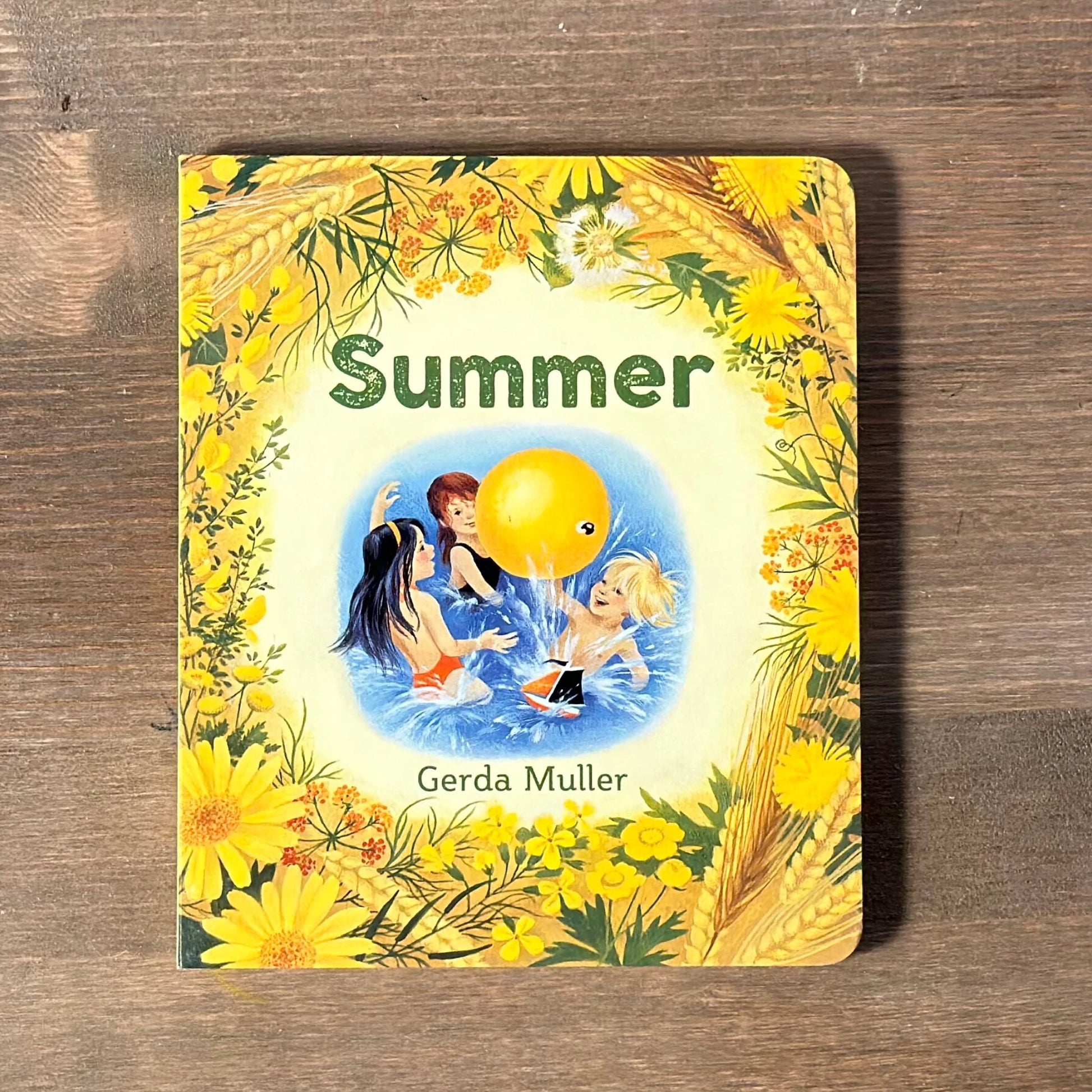 Summer Board Book by Gerda Muller on a wooden tabletop