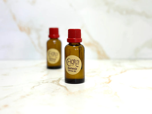 Two bottles of String Oil by Choroi for String Instruments on a white background