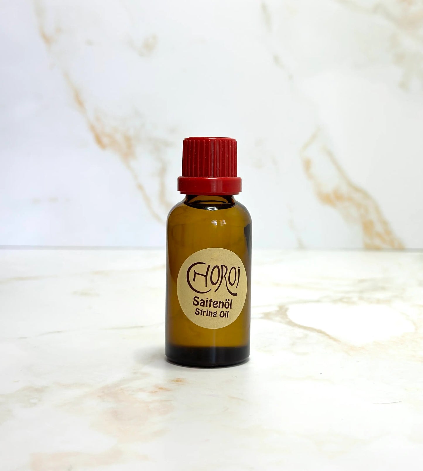 One bottle of String Oil by Choroi ona  marble background