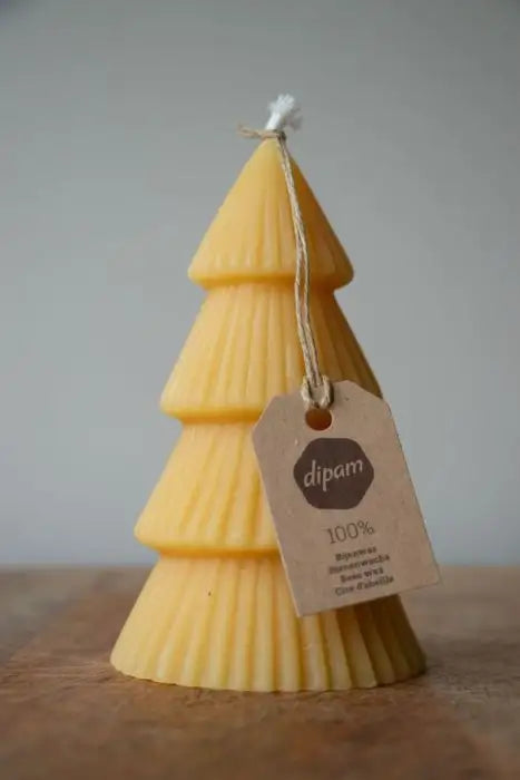 A Dipam Christmas Tree Candle on a table top