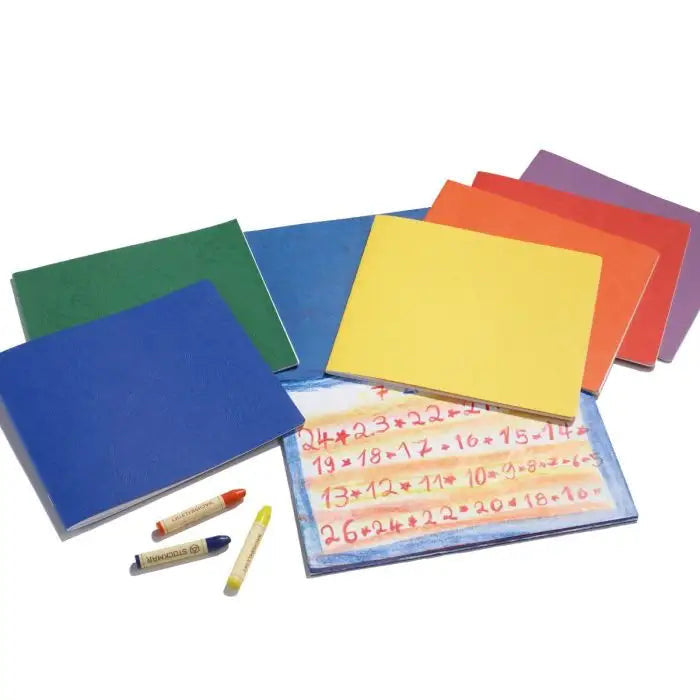 Multiple Small Main Lesson Book, Landscape Style fanned out on a white background with stick crayons