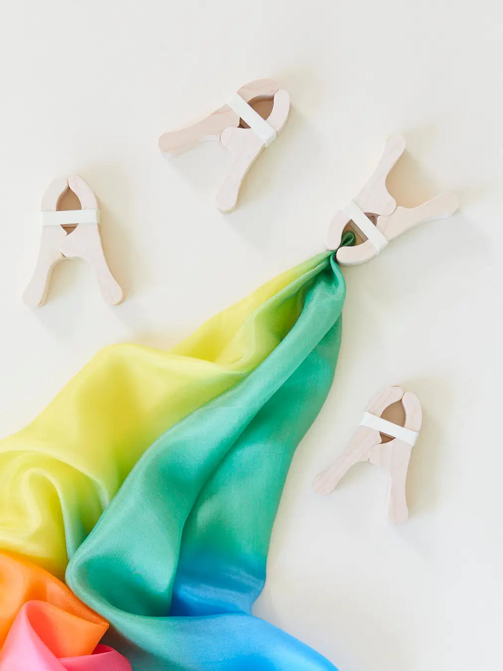 four Sarah’s Silks Playcloth Clips and a rainbow playsilk
