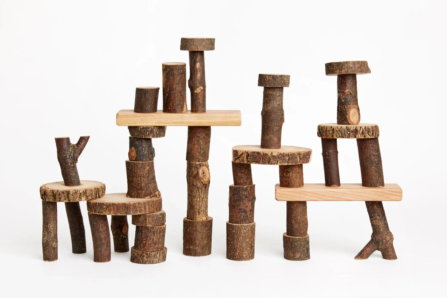 Barked Tree Blocks for open ended play stacked against a white background