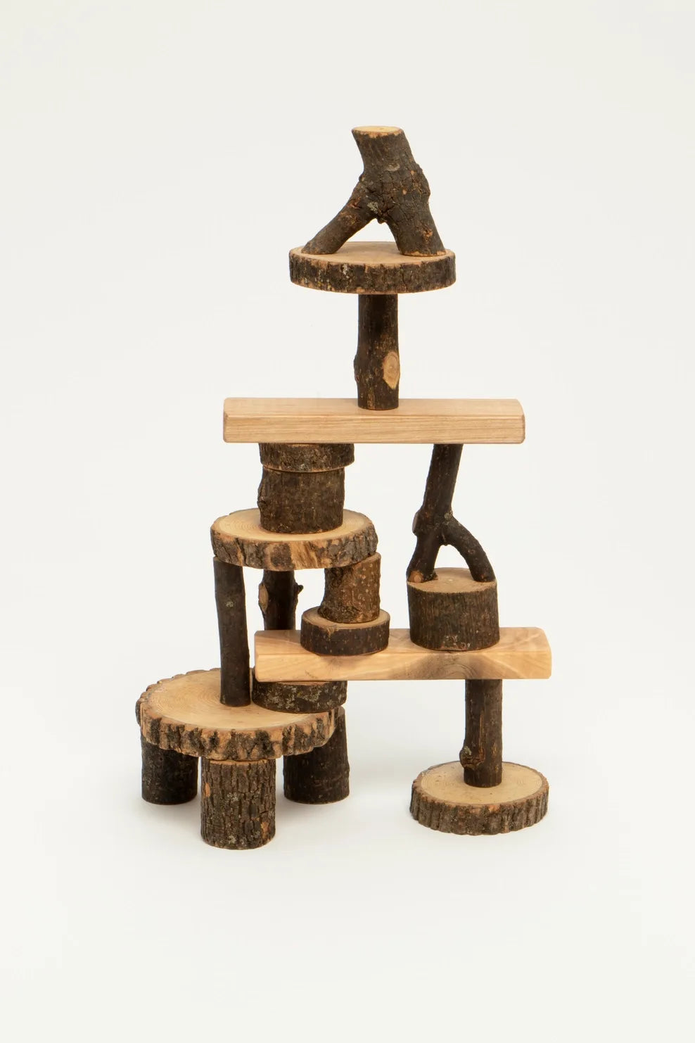 Barked Tree Blocks for open ended play stacked against a white background