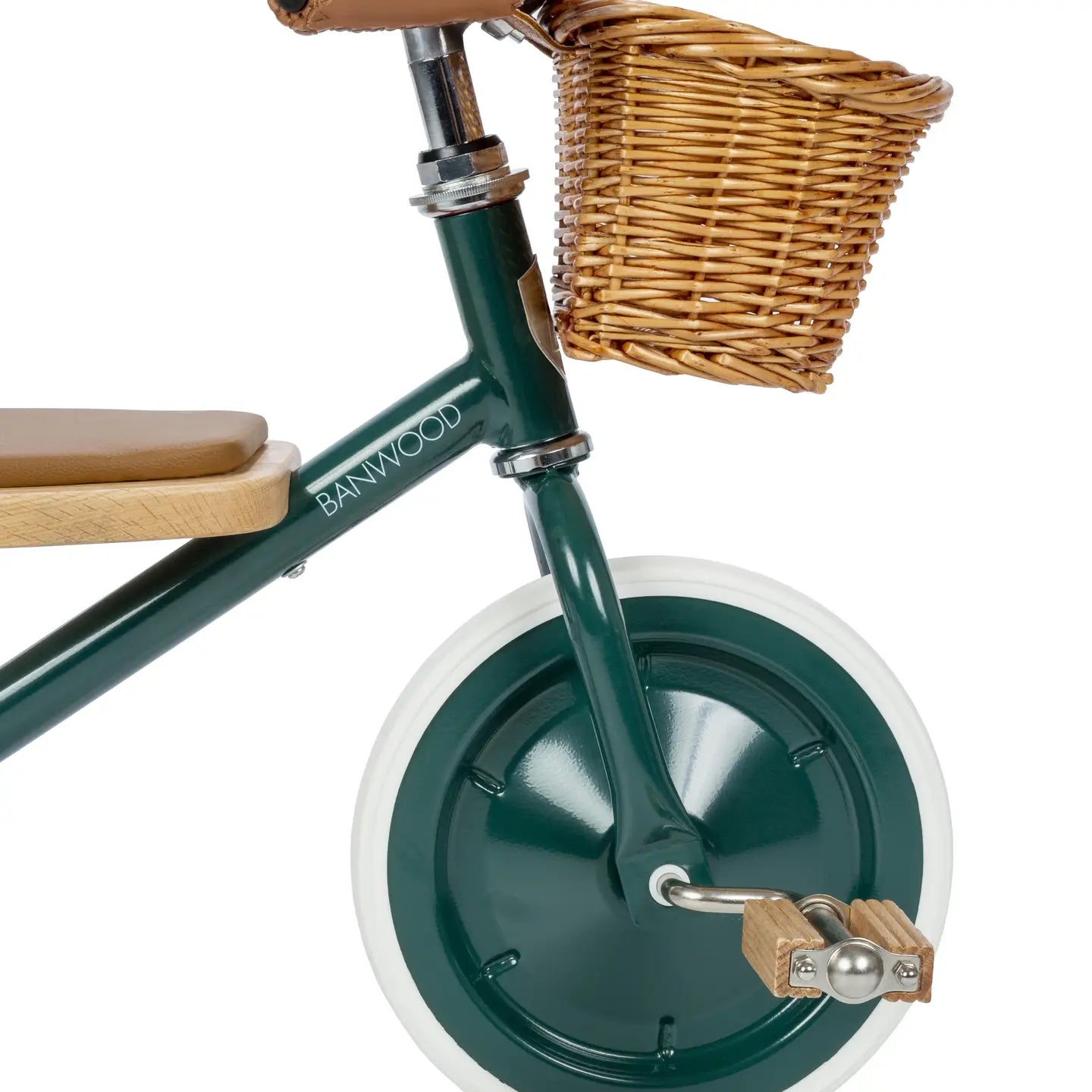 Green tricycle with a wicker basket and wooden seat on a white background