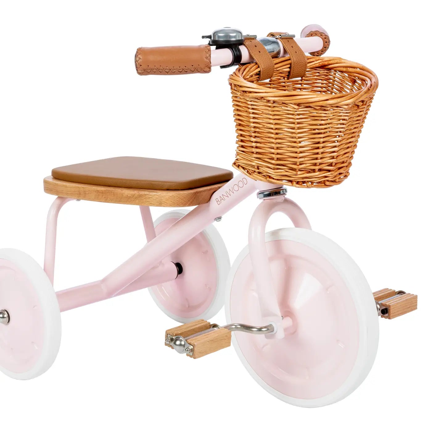 Pink children's tricycle with a wicker basket on a white background