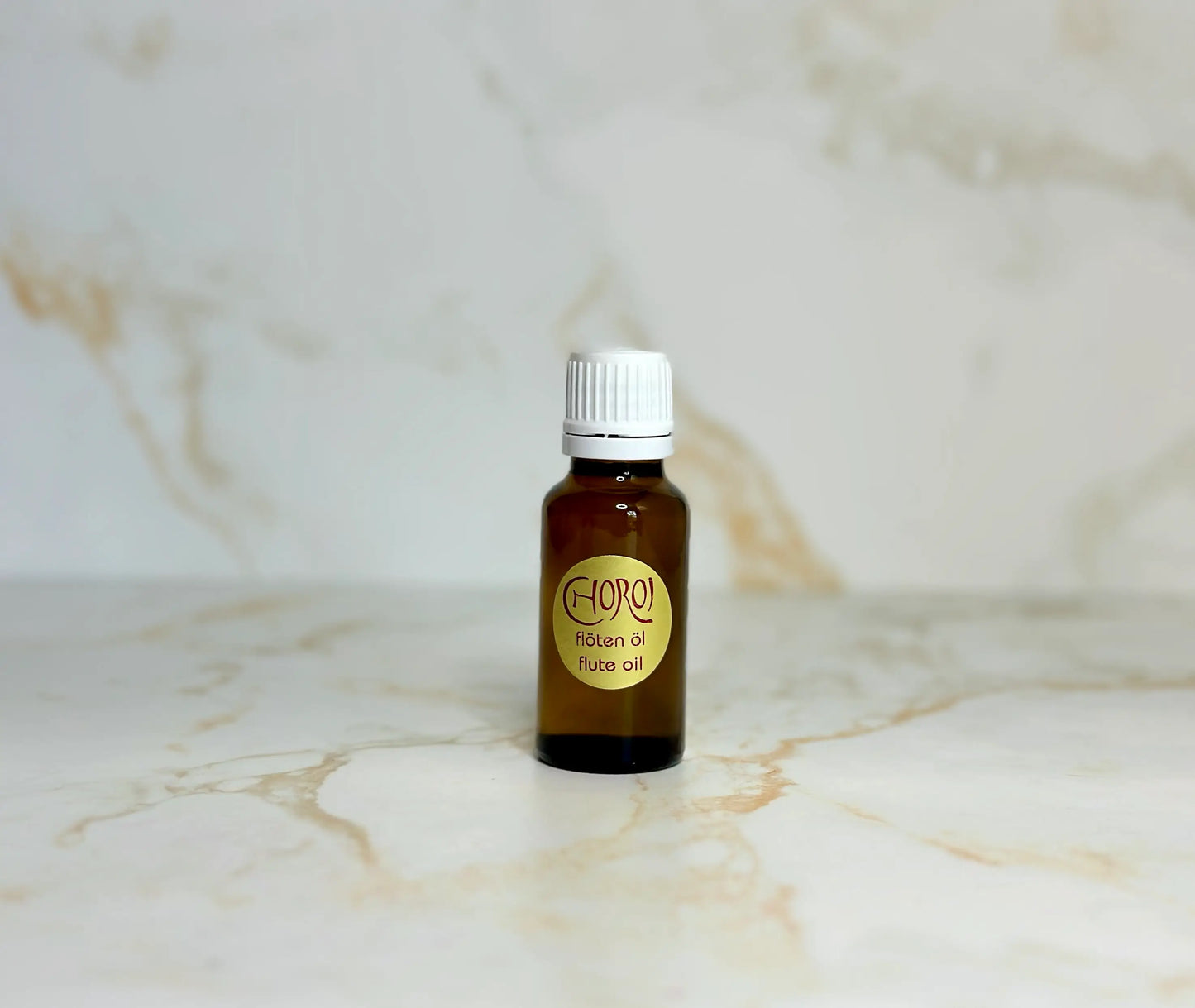 Choroi wooden flute oil in small glass bottle on marble background