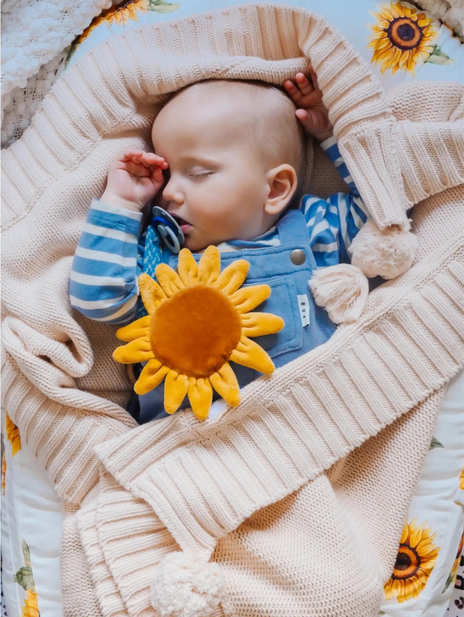 Sleeping baby with organic cotton sunflower crinkle toy