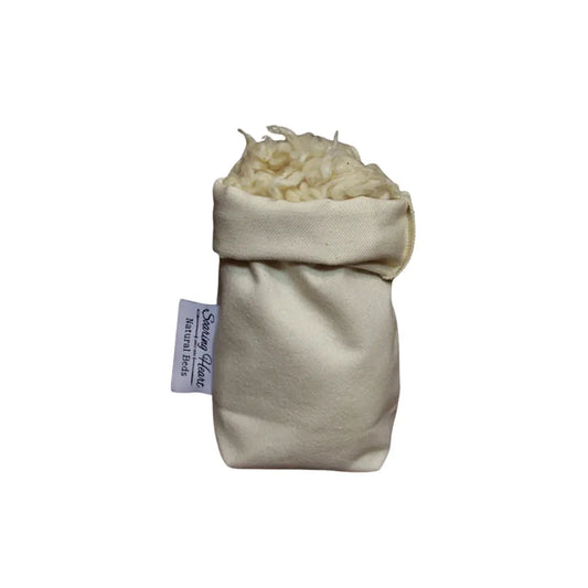 Small bag of white kapok stuffing fibers with a label on a white background