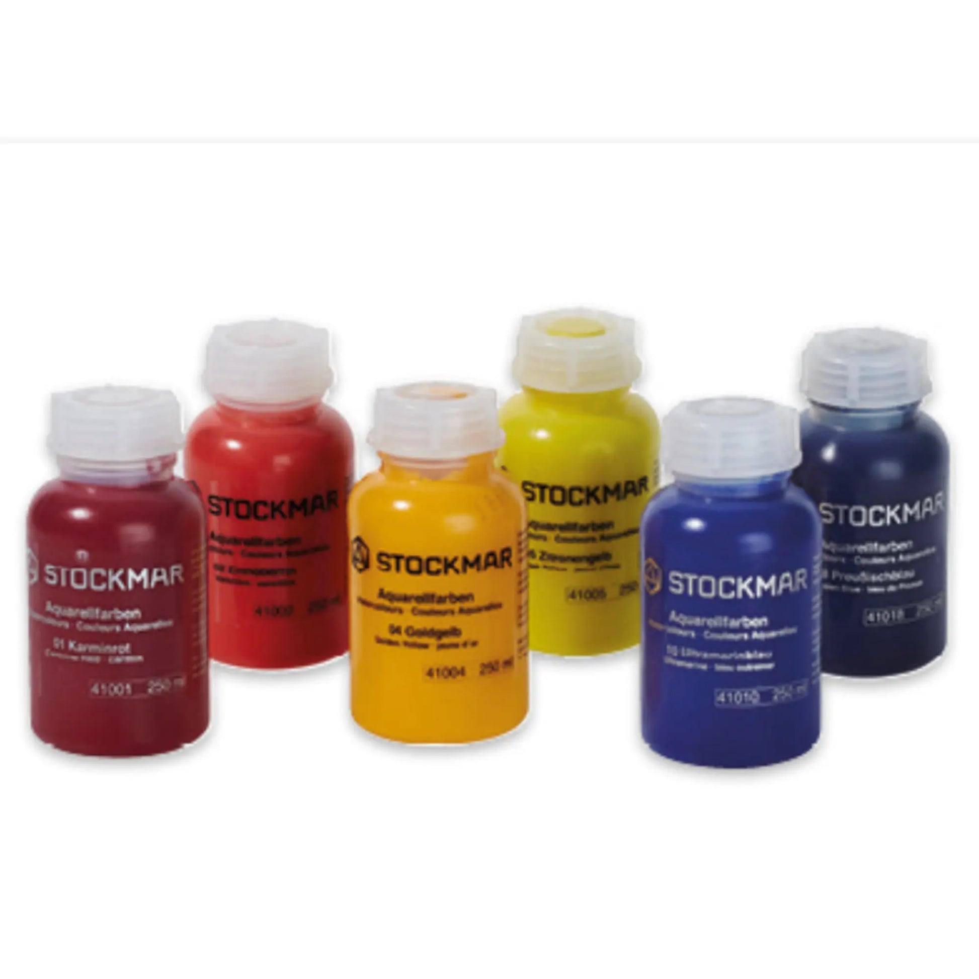 Set of Stockmar watercolors in red, orange, yellow, blue, and purple on a white background.
