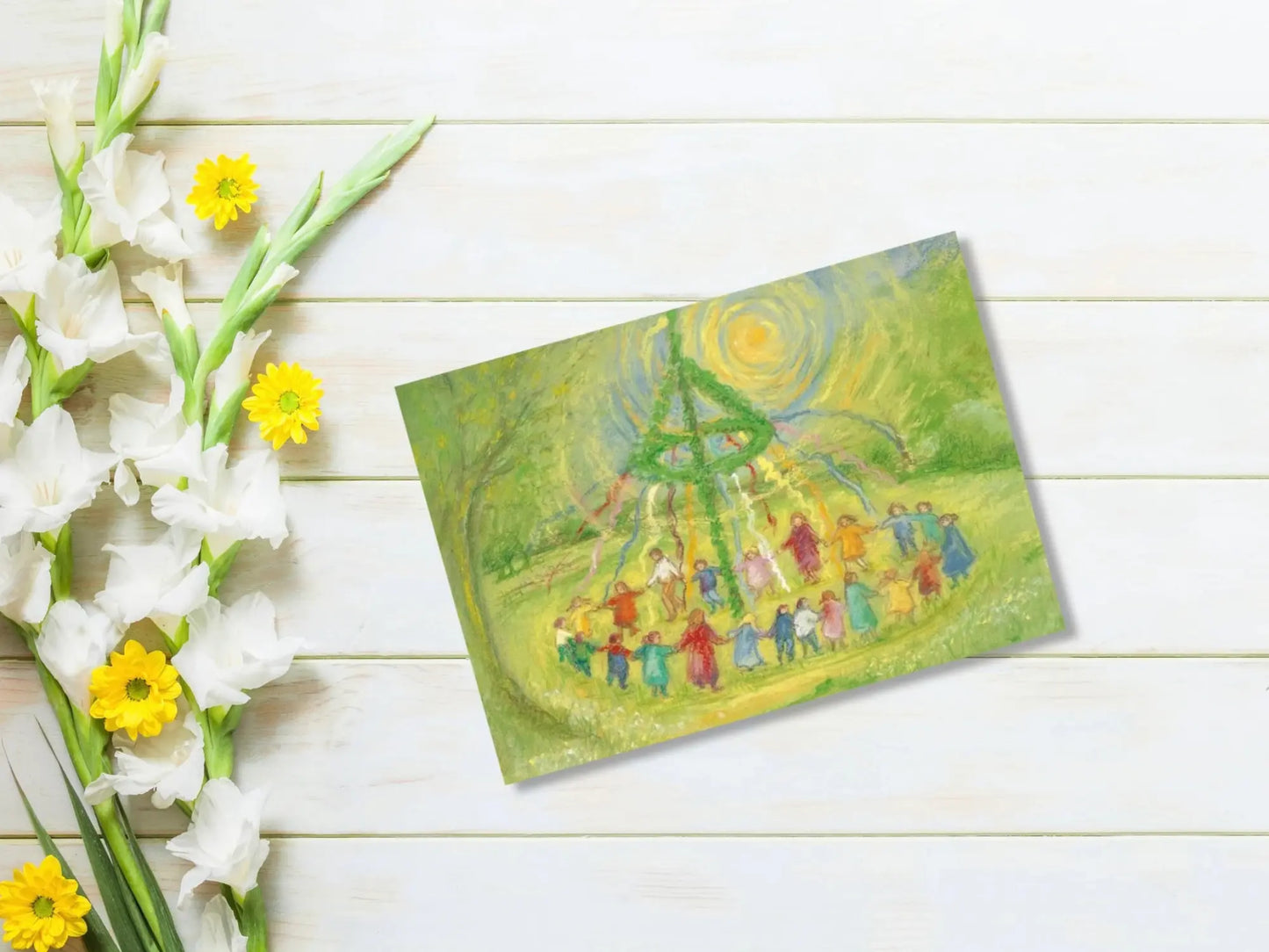 Colorful illustration of a group of people around a Maypole on a wooden surface with flowers.