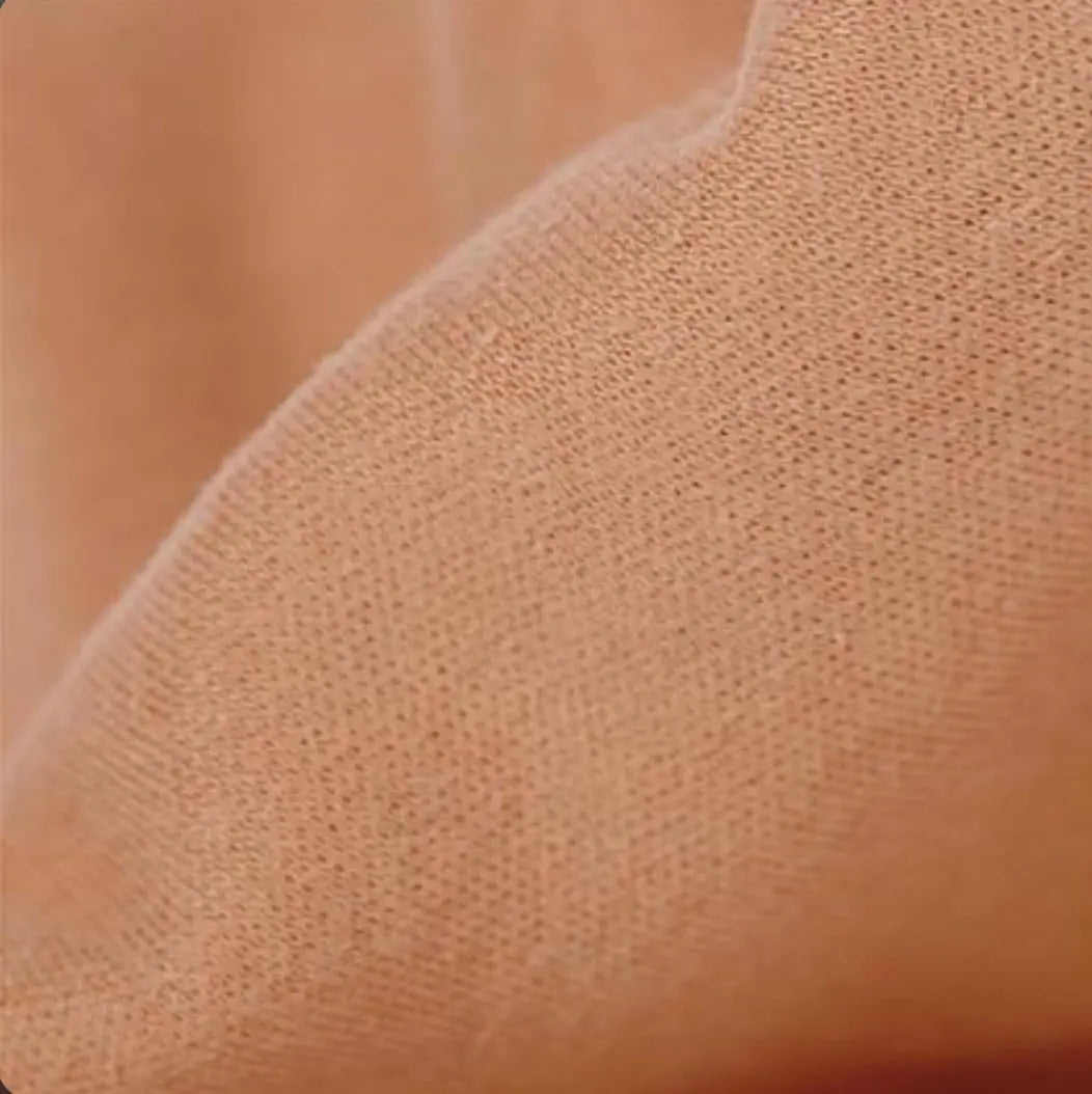 Close-up of textured coffee colored brown organic cotton tricot dollmaking fabric