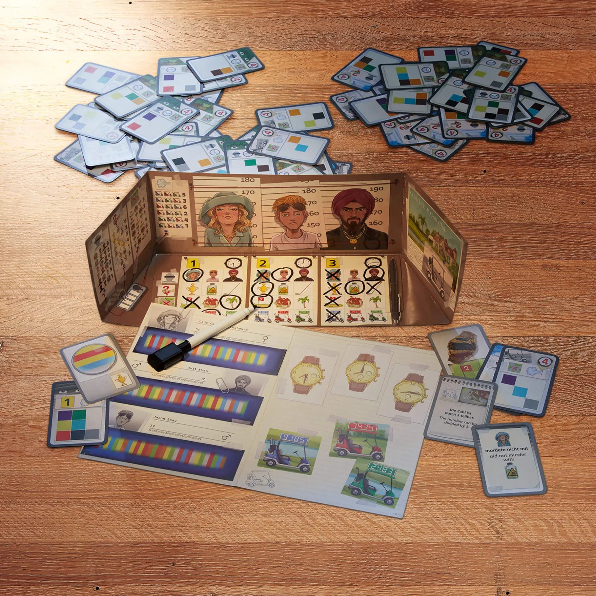 Kids clue mystery board game components including cards and a box on a wooden surface