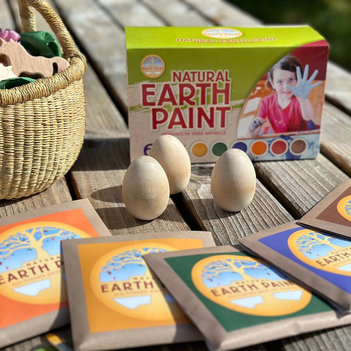 Natural Earth Paint kit with wooden eggs and packaging on a wooden surface