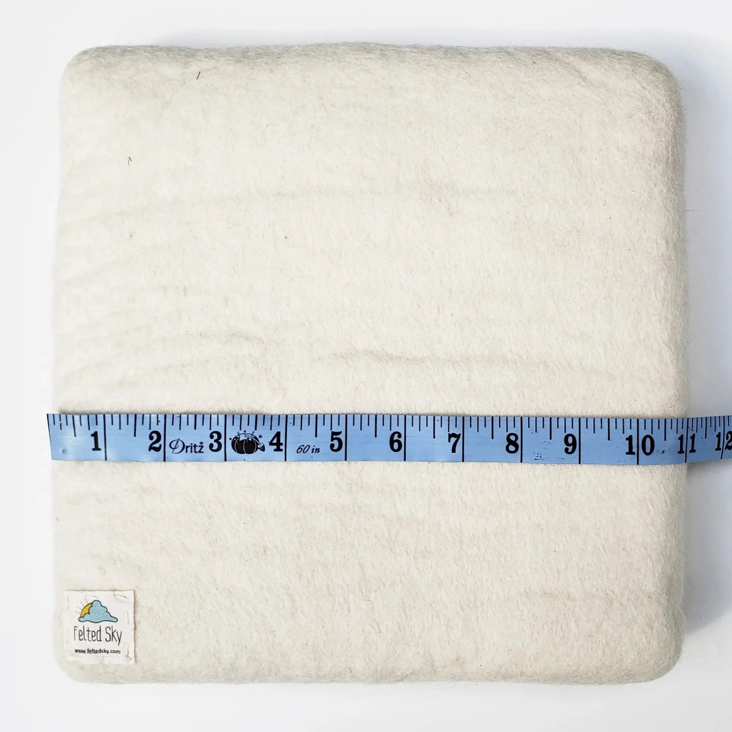 White needle felting mat with a measuring tape  showing 11" on a white background