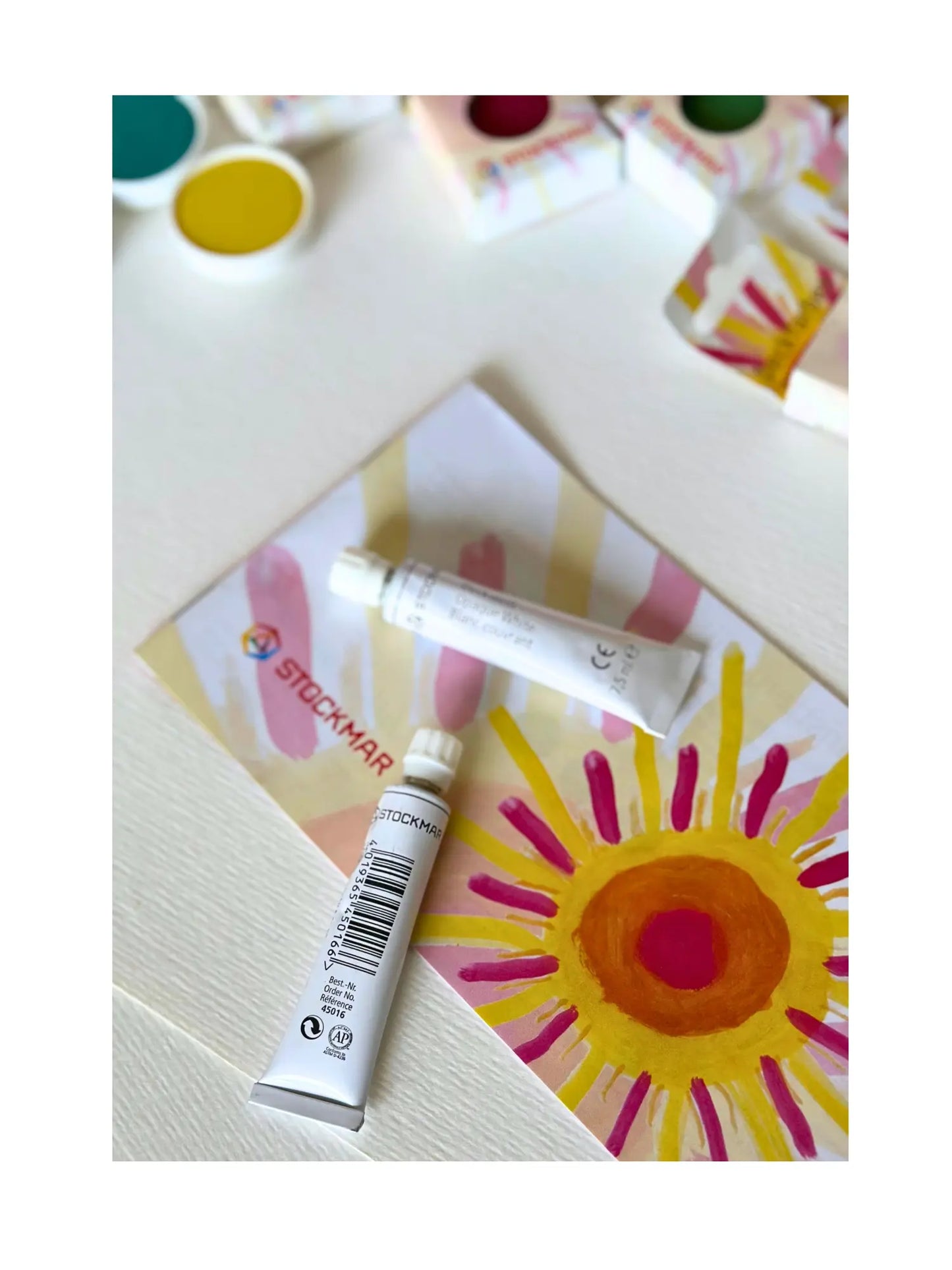Stockmar Opaque Paint White Tube on Stockmar brochure with a painted sun