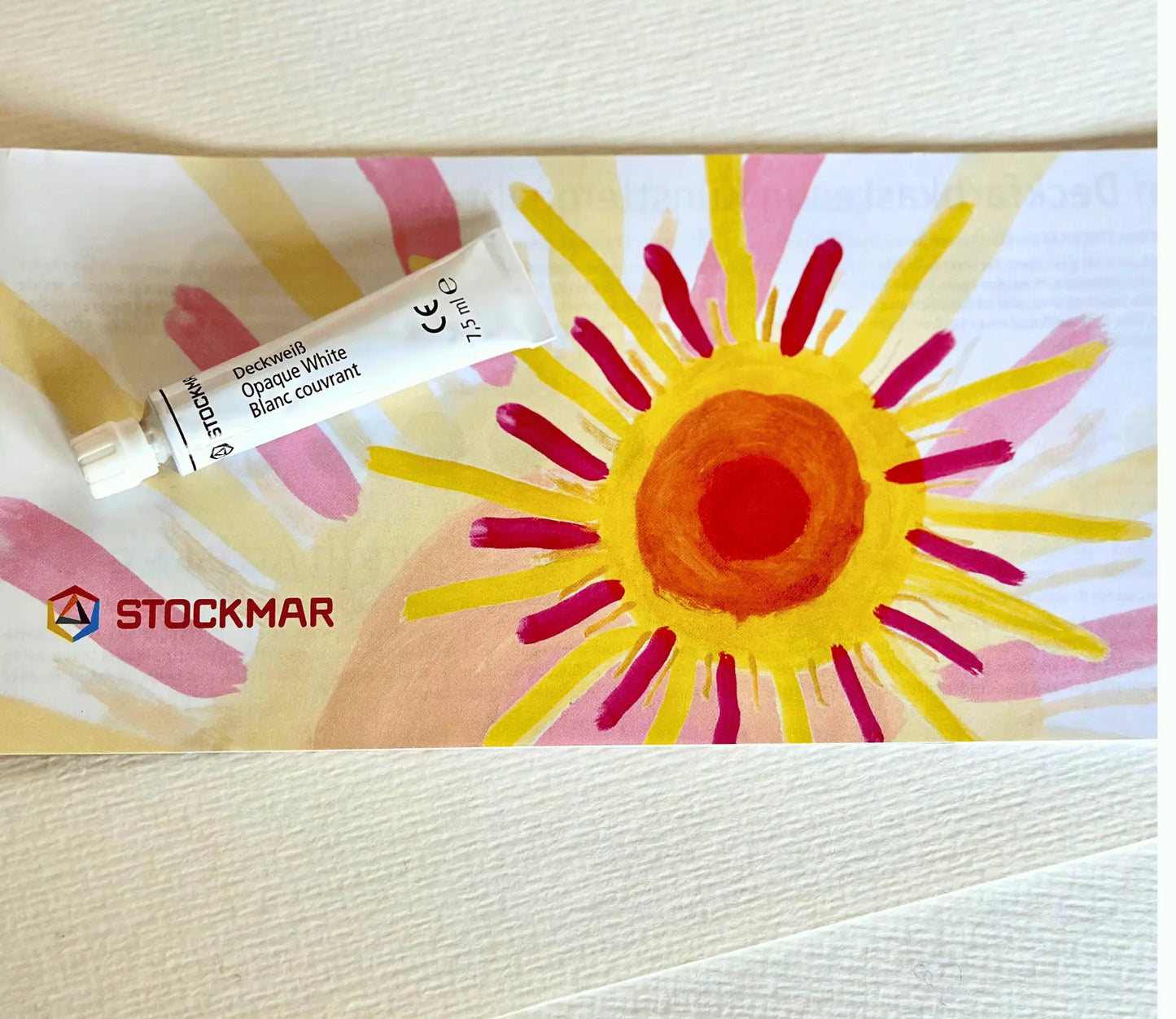 Stockmar Opaque Paint White on Stockmar's brochure with a painted sun