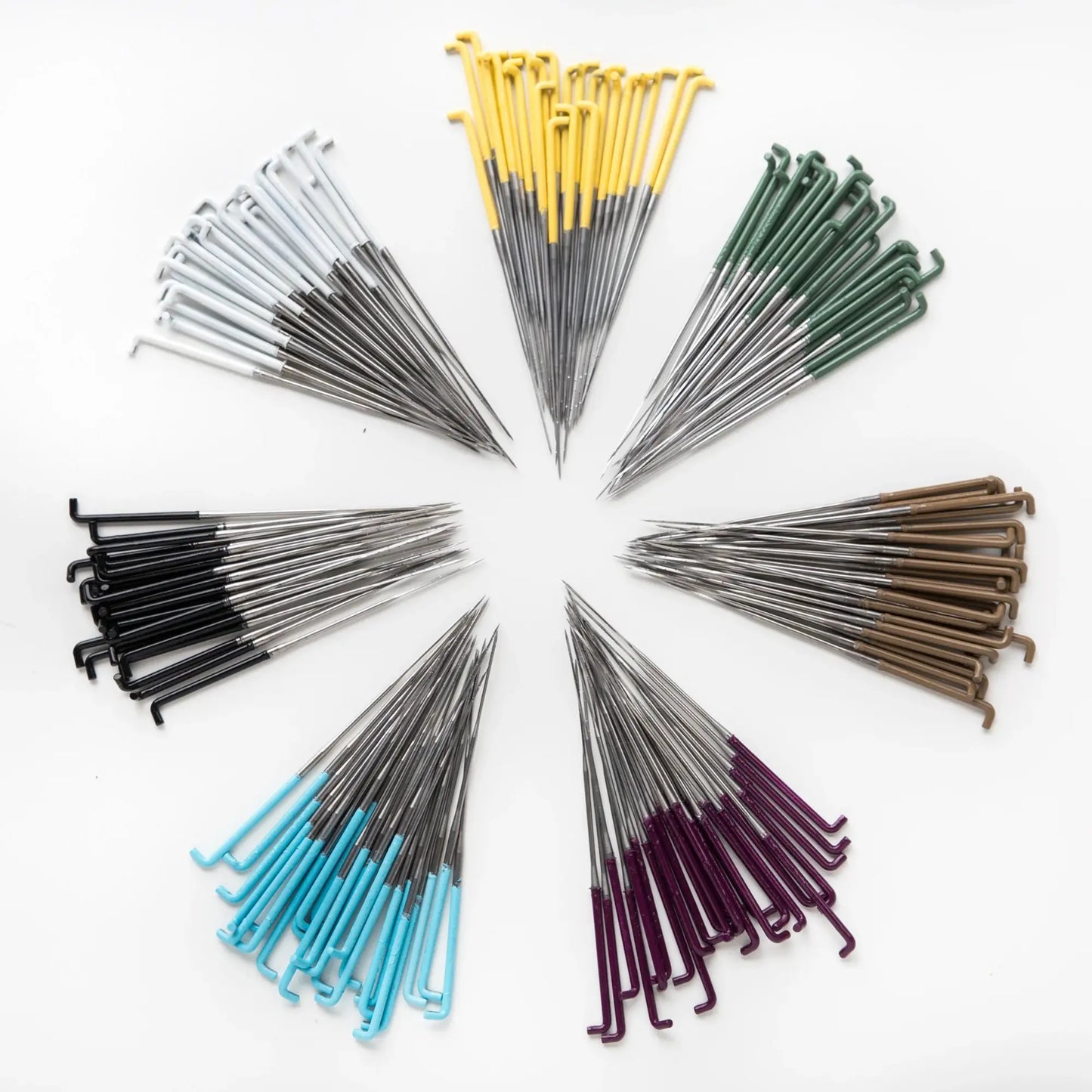 Painted Felted Needles Arranged By Color in a Circle on White Background