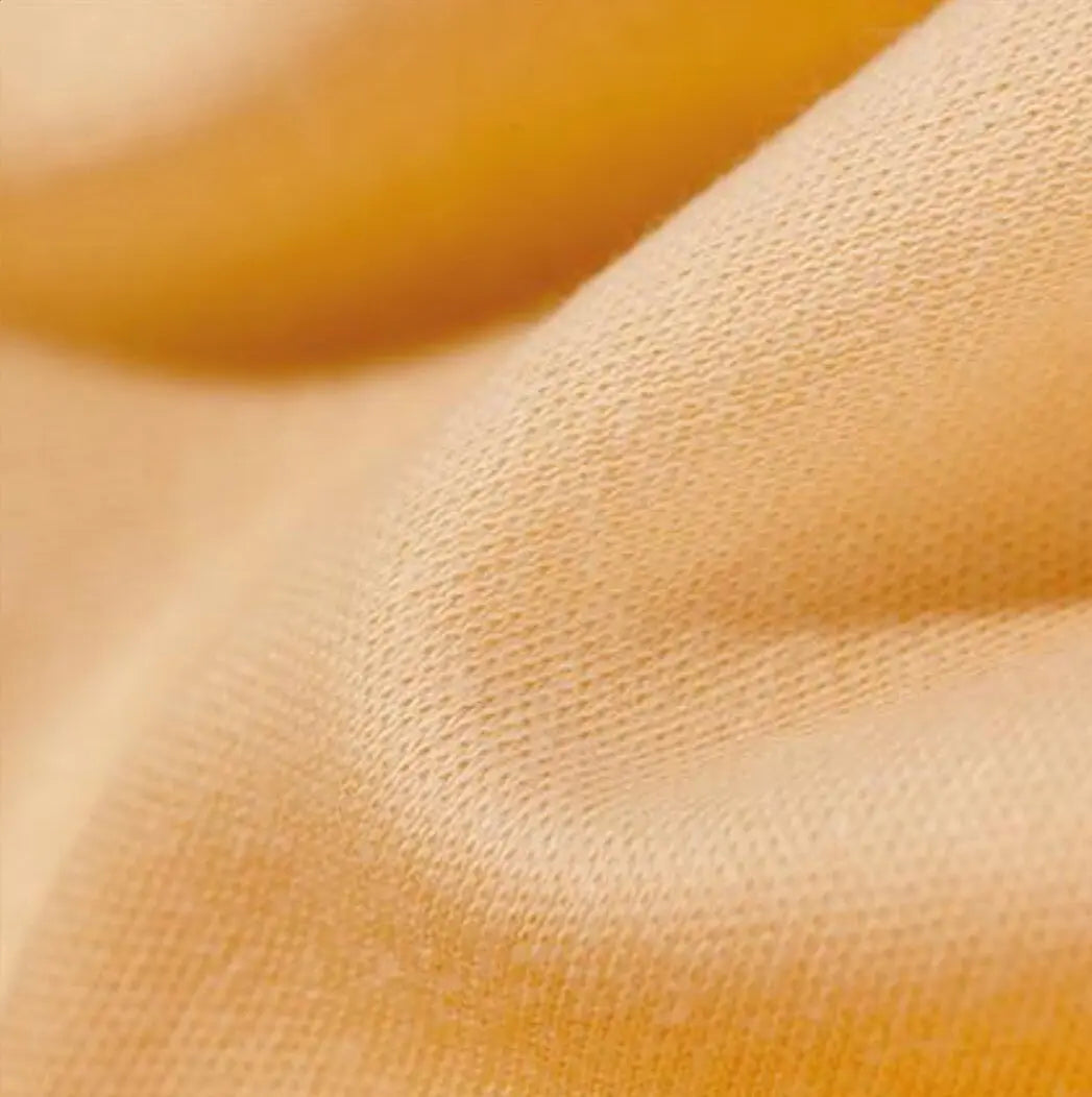 Close-up of textured peach organic cotton tricot dollmaking fabric
