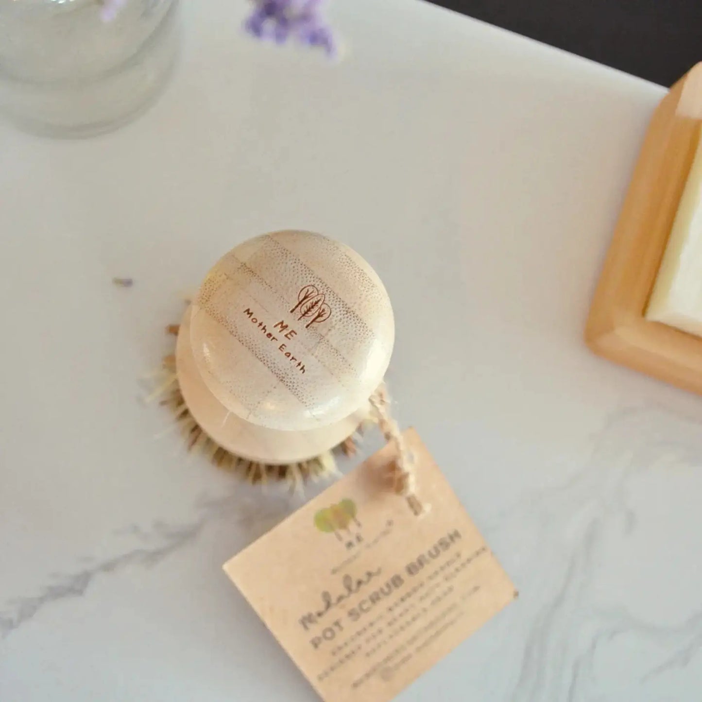 Wooden body brush with a tag on a marble surface