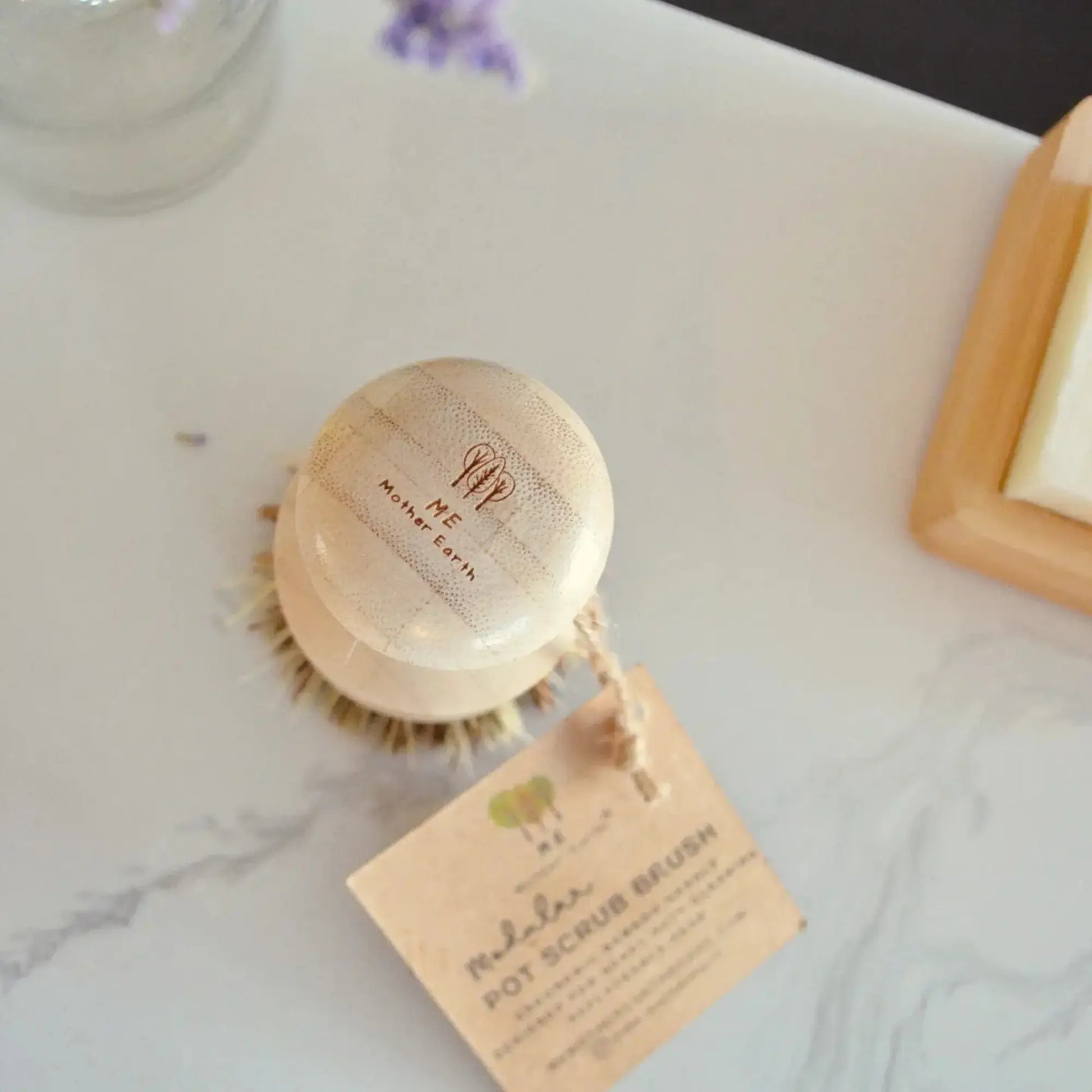 Wooden body brush with a tag on a marble surface