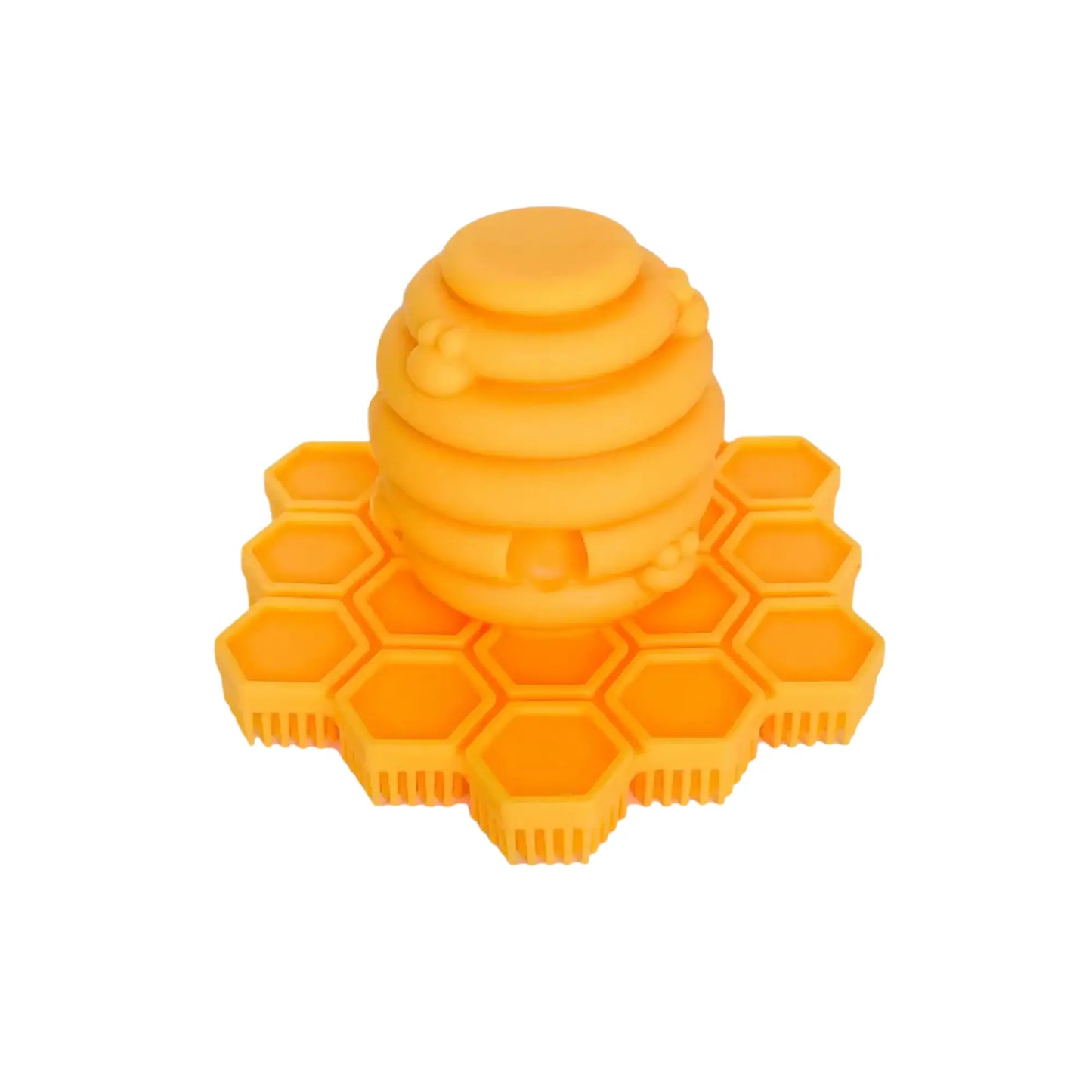 Yellow honeycomb-shaped silicone cradle cap scrubber on a white background
