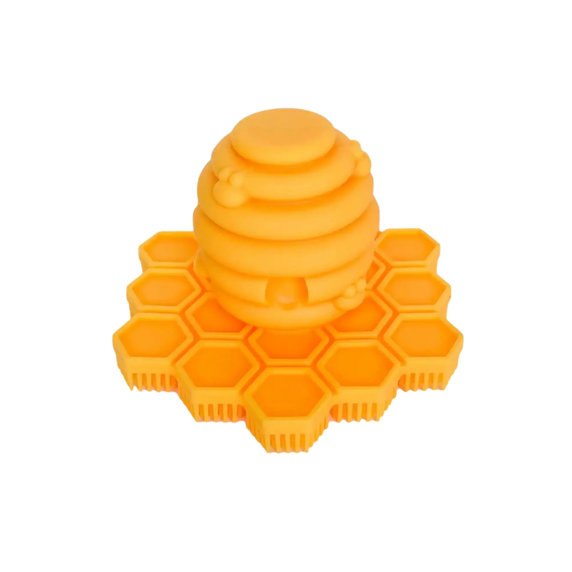 Yellow honeycomb-shaped silicone cradle cap scrubber on a white background