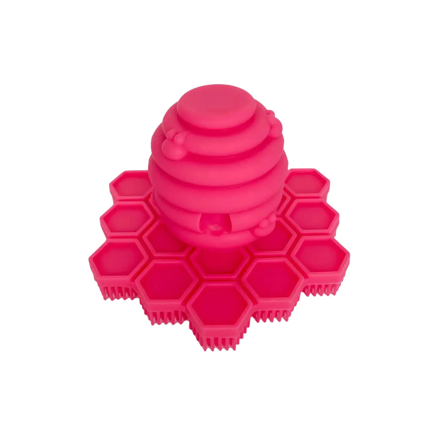 Pink silicone hand scrubber with honeycomb design on a white background