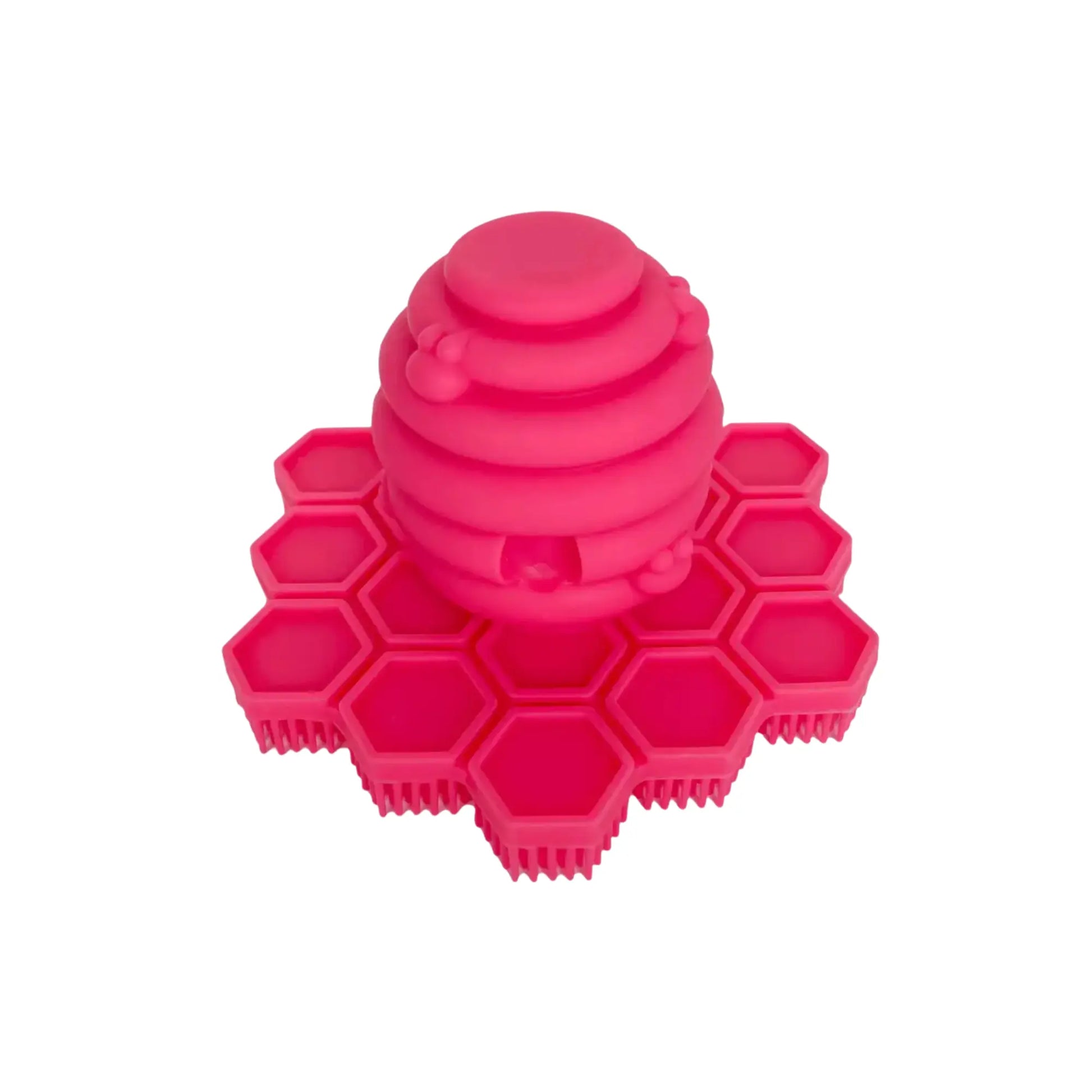Pink silicone hand scrubber with honeycomb design on a white background