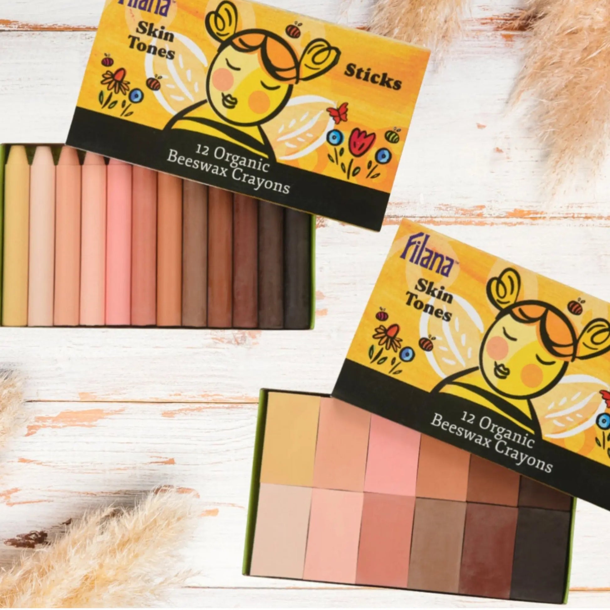Two boxes of Filana Skin Tones Organic Beeswax Crayons on a wooden surface.