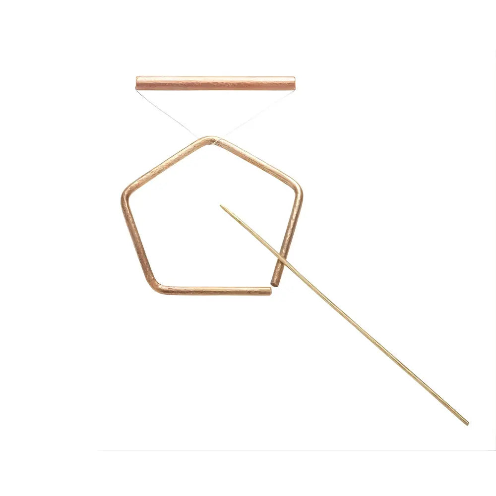 Brass pentangle set on white background