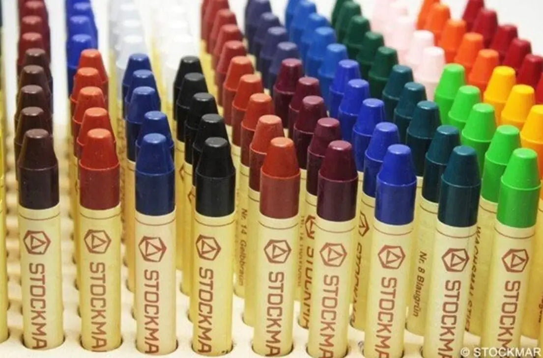 Colorful Stockmar Crayons arranged in rows.